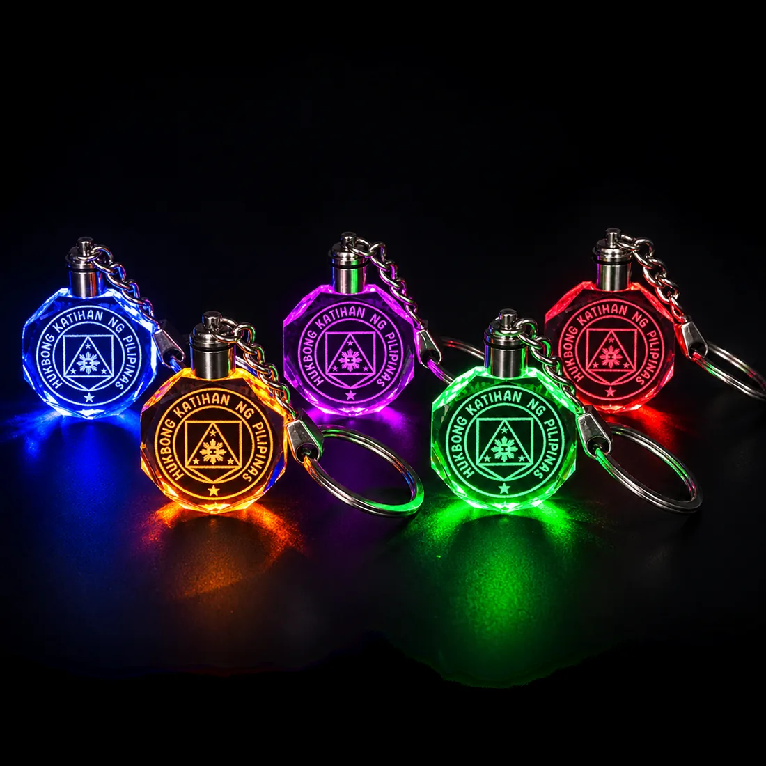 Five crystal keychains etched with the Philippine Army seal, lit blue, orange, purple, green and red